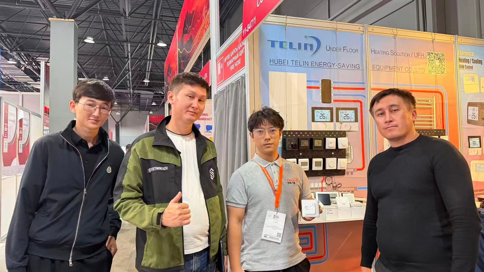 Demonstrating Telin thermostat product for client at Kazbuild Almaty 2026
